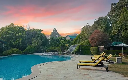 Aahana a Luxury resort pool at sunset, nature perfect for wildlife safari escape in Jim Corbett