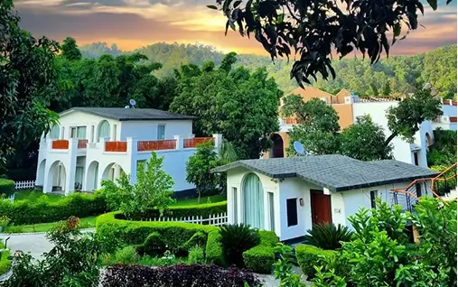 The image shows Villas at The Hridayesh Resort, a luxury gateway in Jim Corbett National Park, India