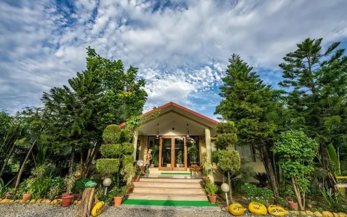 Spacious garden and pool view at family hotels and resorts in Jim Corbett.