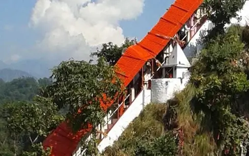 Best places to visit in Jim Corbett featuring the famous Garjiya Devi Temple on the Kosi River rock.