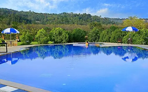 Luxury riverside hotels and resorts in Jim Corbett near the Dhela monsoon river bank.